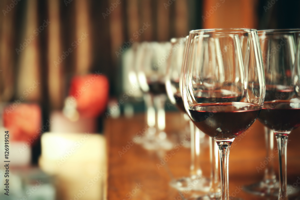 Glasses of red wine on bar counter