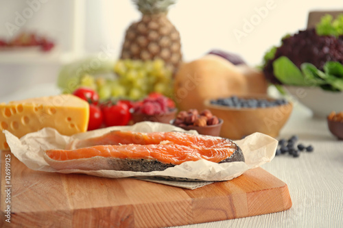 Slice of red fish on wooden cutting board