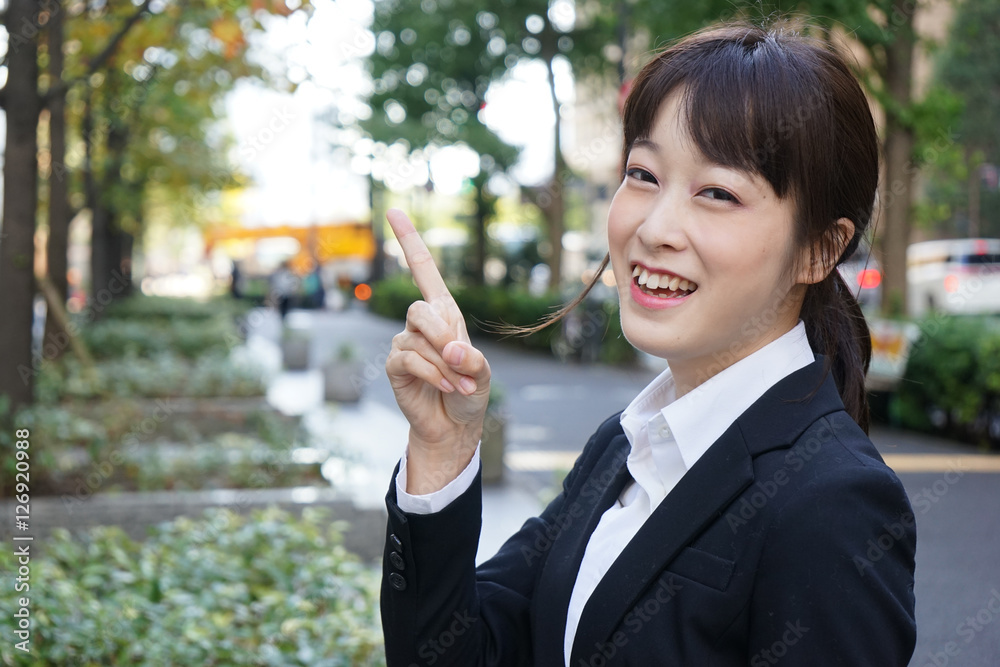 Young business woman pointing something with smile Young business woman pointing something with smile