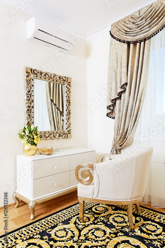 White console-mirror with chair in golden ornamentation photo