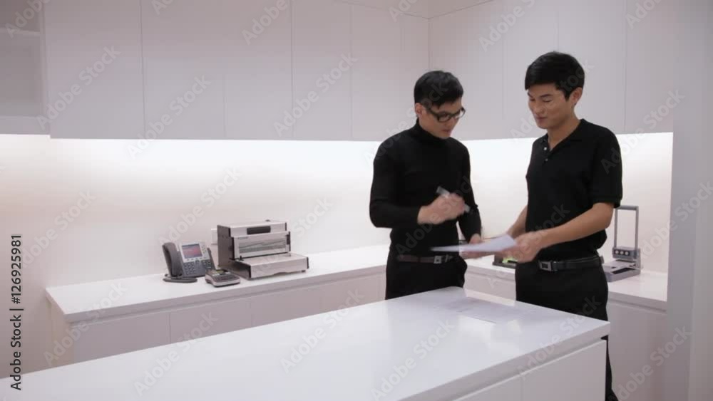 MS Two man talking by table in office / China MS Two man talking by table in office / China