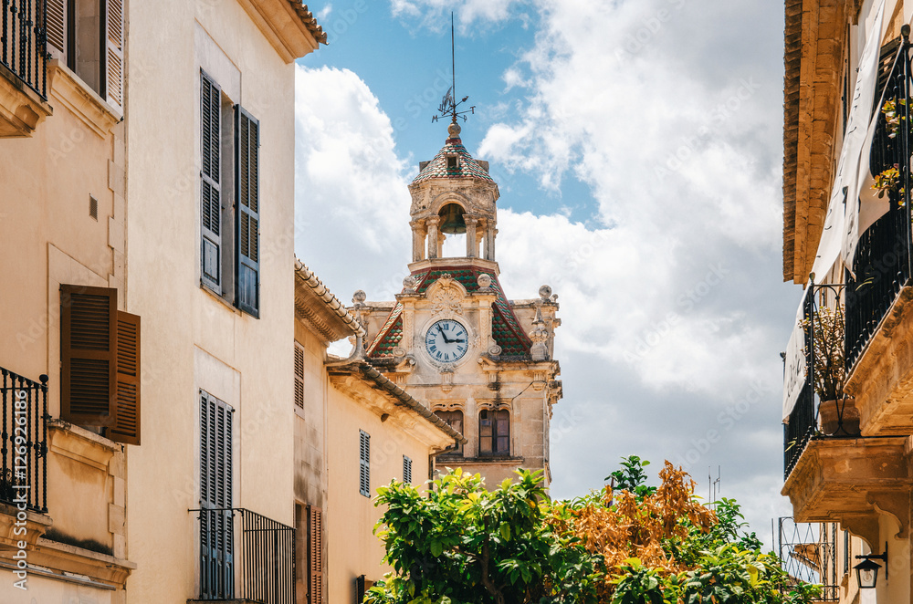 Architecture of Majorca. The tower with big clock of City town hall in Old Town of Alcudia, Mallorca, Balearic island, Spain