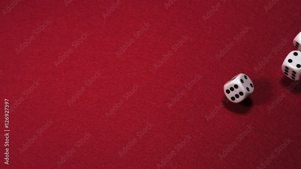 Dice rolling against Red background, slow motion Dice rolling against Red background, slow motion