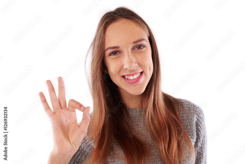 Slender brown hair girl in warm clothes shows the symbol of sati Slender brown hair girl in warm clothes shows the symbol of sati