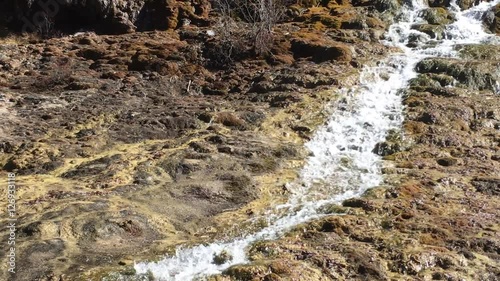 Waterfall stream at Huanglong Mountain with beautiful nature lime stone  in Sichuan , China on sunny day
