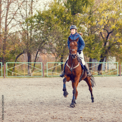 Sportswoman riding horse on equestrian competition