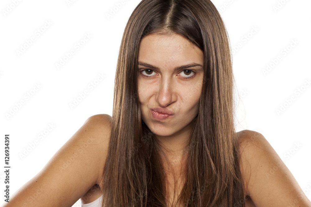 young angry woman looking with distrust at camera young angry woman looking with distrust at camera