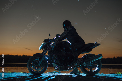 Canvas Print Male biker sitting on motorbike