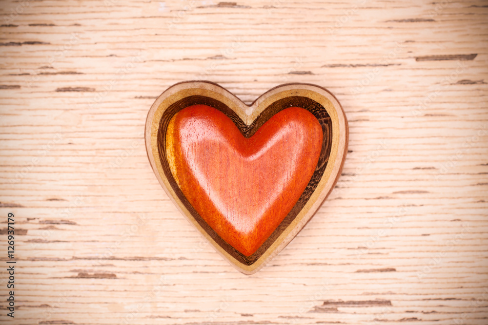 One wooden heart on rustic wood background. Valentines days conc One wooden heart on rustic wood background. Valentines days conc