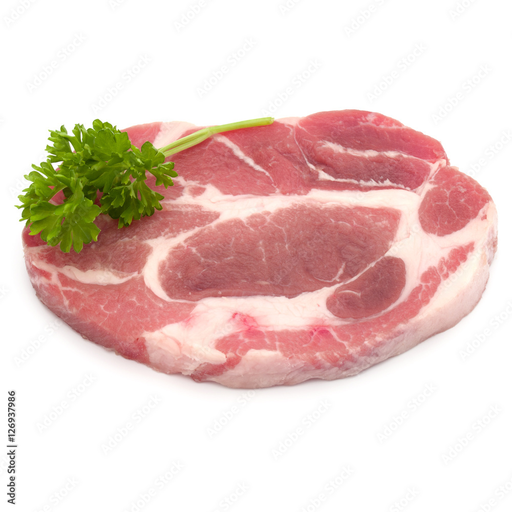 Raw pork neck chop meat with parsley herb leaves garnish isolate Raw pork neck chop meat with parsley herb leaves garnish isolate