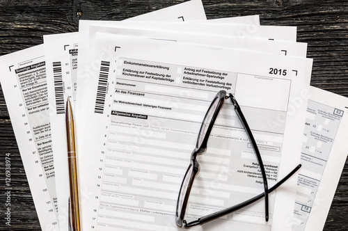 Obraz na plátně German tax form with pen and glasses on a table. Top view.