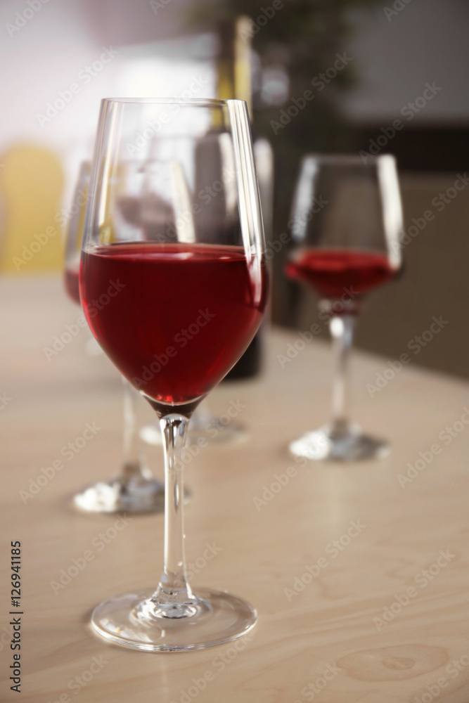 Glasses of red wine on table in restaurant