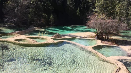 Huanglong Mountain with beautiful nature lime stone pond  ,waterfalls,lake  in Sichuan , China on sunny day