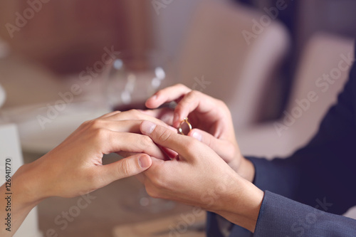 Man making marriage proposal to girlfriend at restaurant  closeup