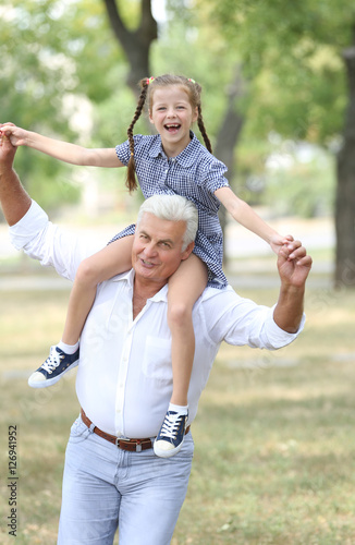 Grandfather with granddaughter in park