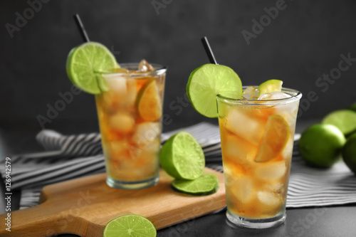 Glasses of iced tea with lime slices on table