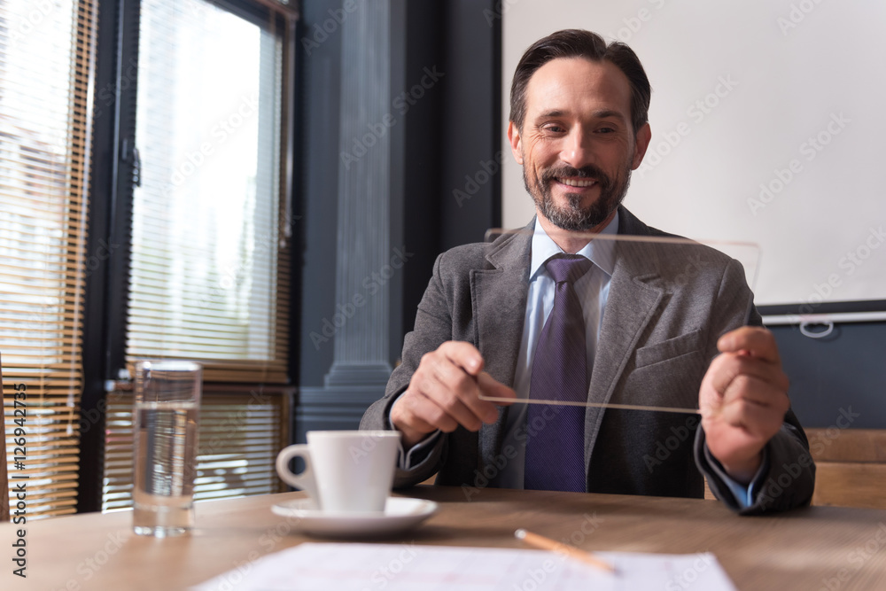 Cheerful successful businessman holding a the tablet Cheerful successful businessman holding a the tablet