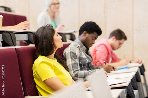 group of students with notebooks in lecture hall