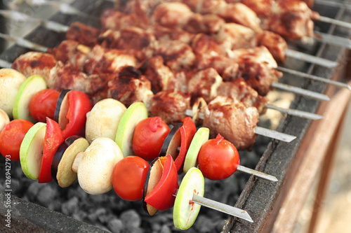 Fresh tasty barbecue with vegetables in brazier outdoors