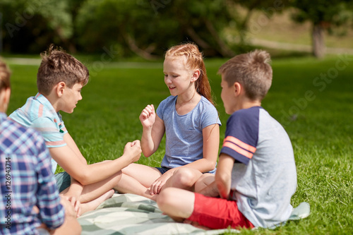 happy kids playing rock-paper-scissors game