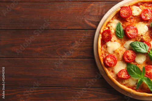 Pizza Margarita on wooden background