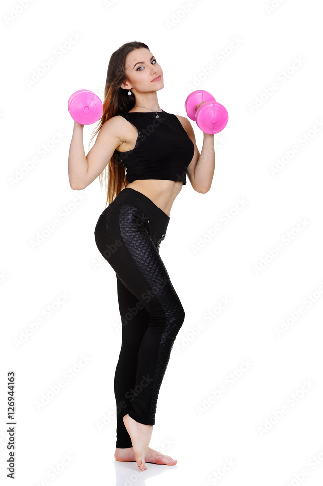 beautiful young woman in black sportswear with pink dumbbells in hands on a white background beautiful young woman in black sportswear with pink dumbbells in hands on a white background