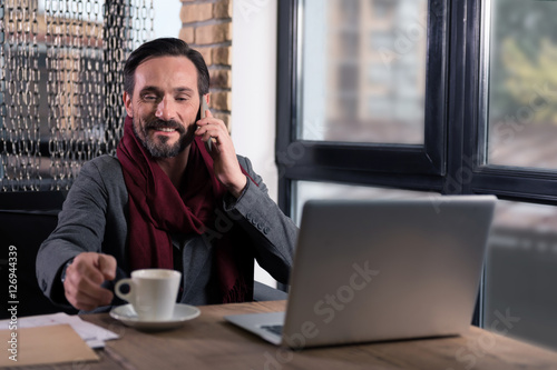 Good looking happy man having coffee
