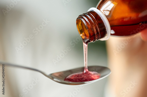 medication or antipyretic syrup and spoon photo