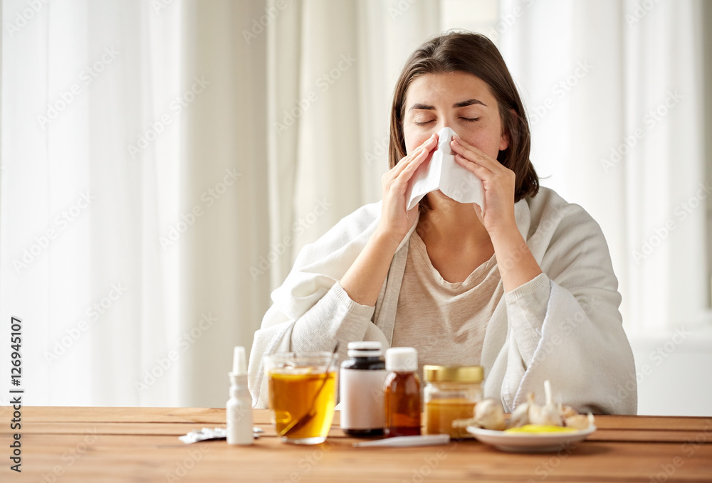 sick woman with medicine blowing nose to wipe sick woman with medicine blowing nose to wipe