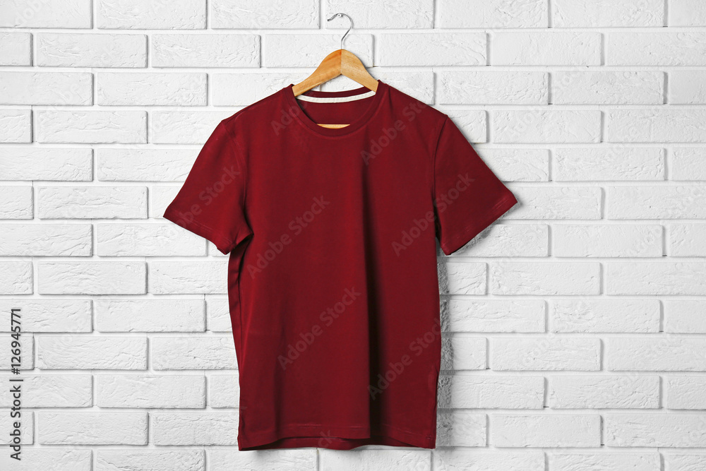 Blank maroon t-shirt against brick wall Blank maroon t-shirt against brick wall