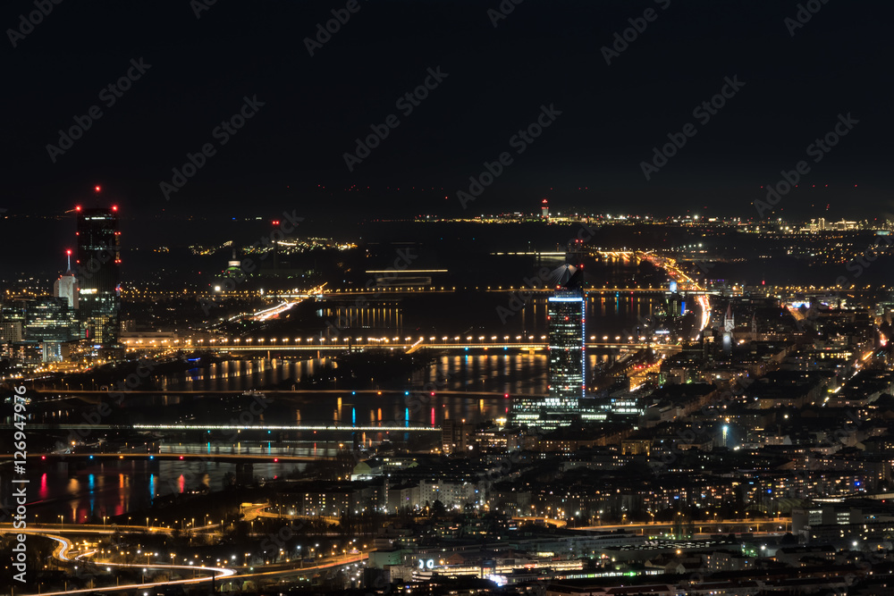 Vienna, aerial view at night with the river danube