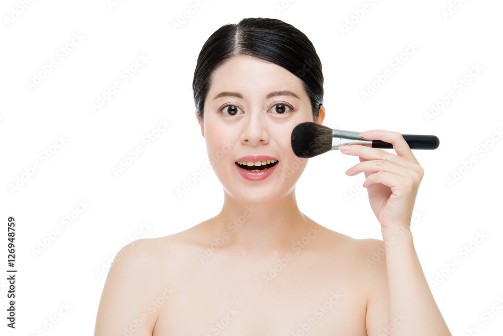 Close up of Smile woman with makeup brushes near face Close up of Smile woman with makeup brushes near face