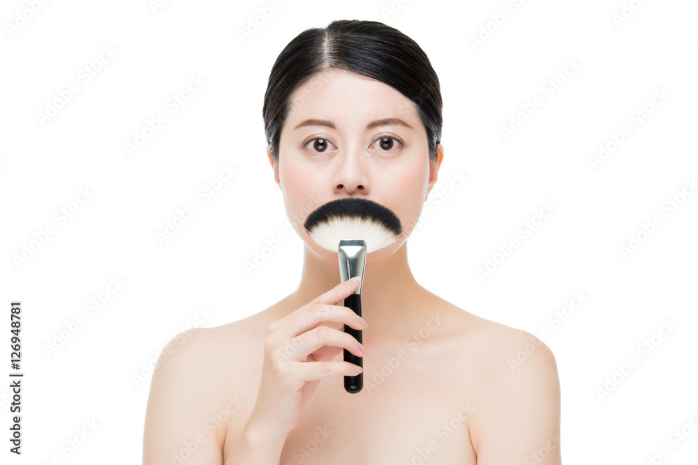 beautiful asian model cover her mouth with makeup brush beautiful asian model cover her mouth with makeup brush
