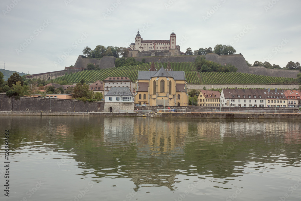 Fortress Marienberg and the St. Burkard church with vineyard on the bank of the Main river