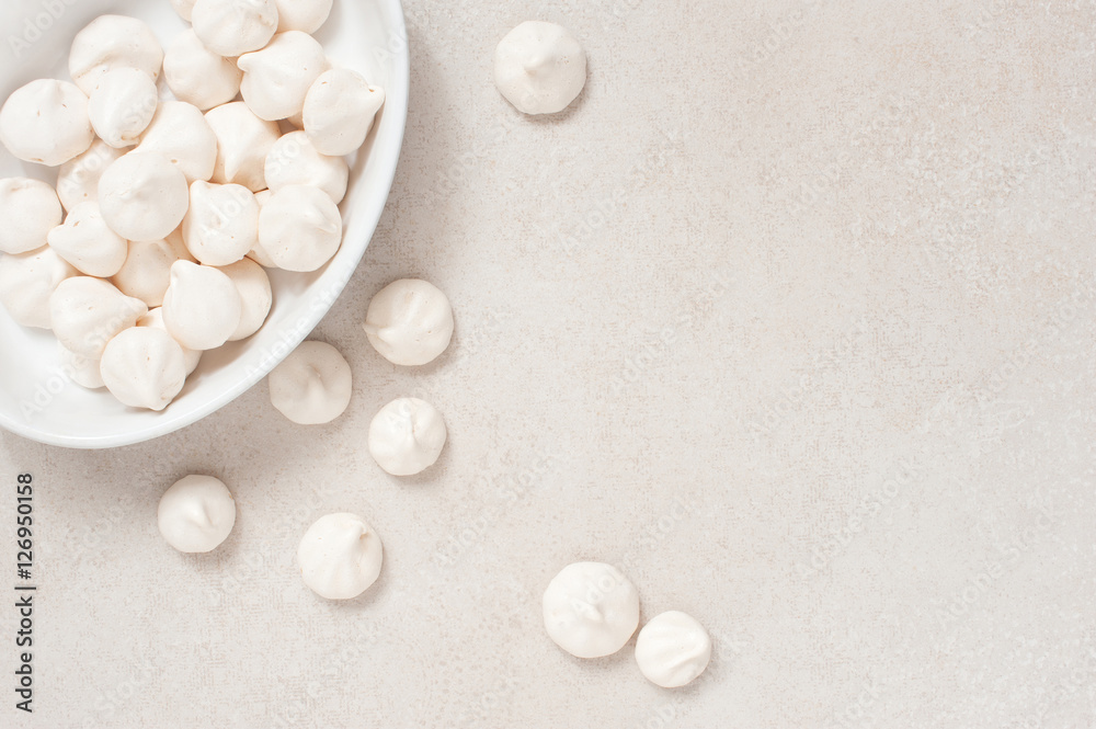 White meringues on the white plate