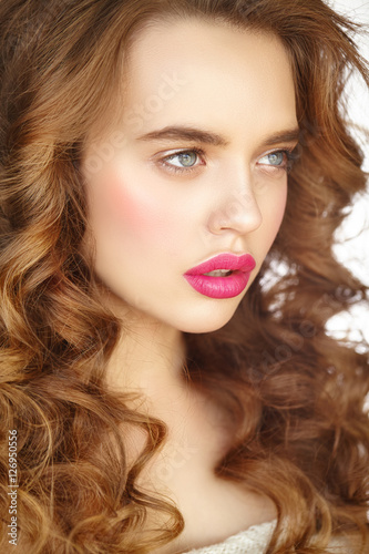 Portrait of woman with curly hair and pink lips