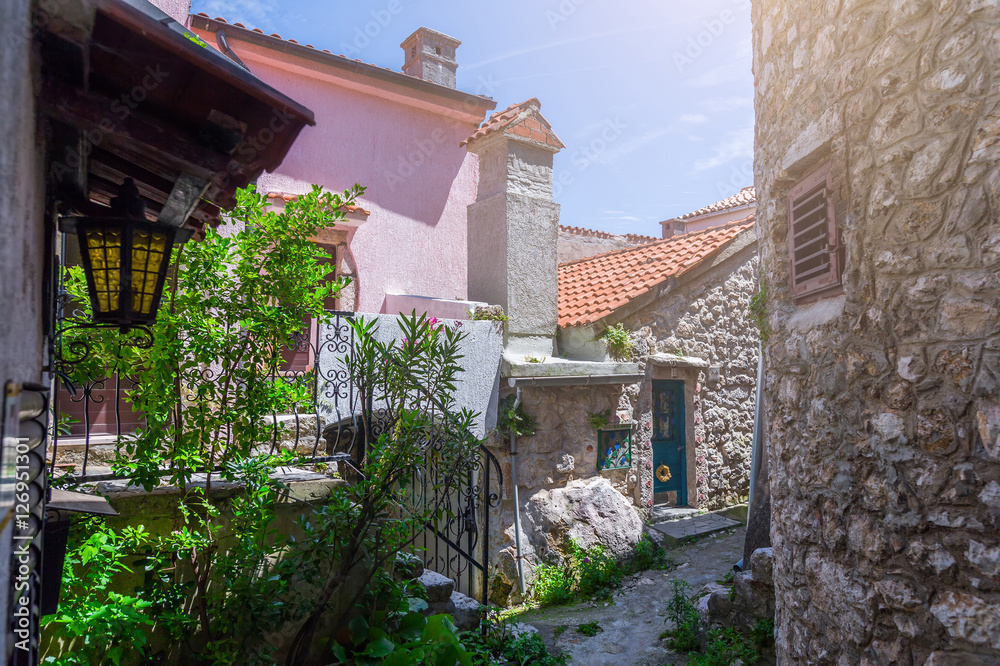Traditional European Mediterranean architectural style in the streets and residential houses, yard, porches, stairs, shutters in the noon sunbeam, surrounded by vine, hydrangea and palm at summertime.