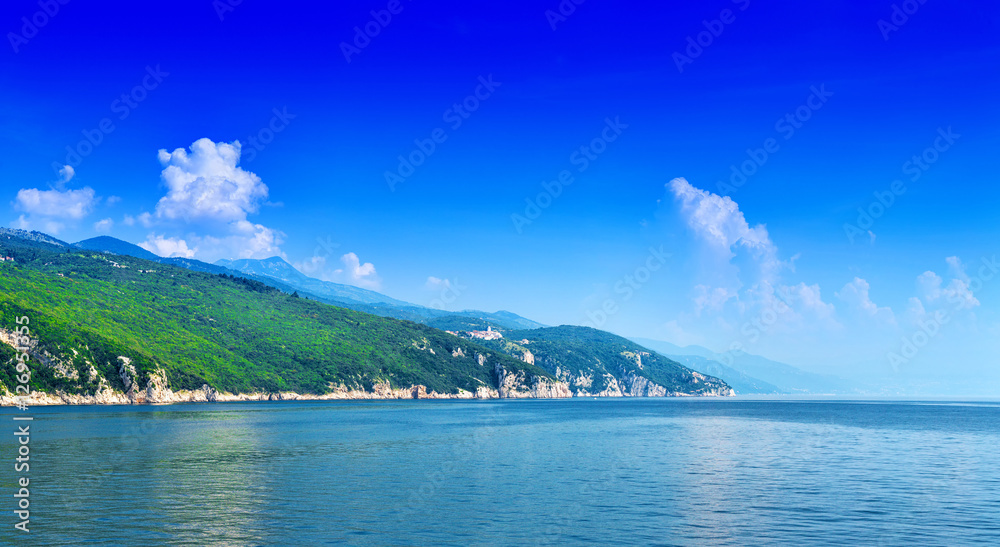 A green coastline in the calm sea in warm summer day. Wonderful romantic landscape panorama Istria peninsula. Croatia. Europe.