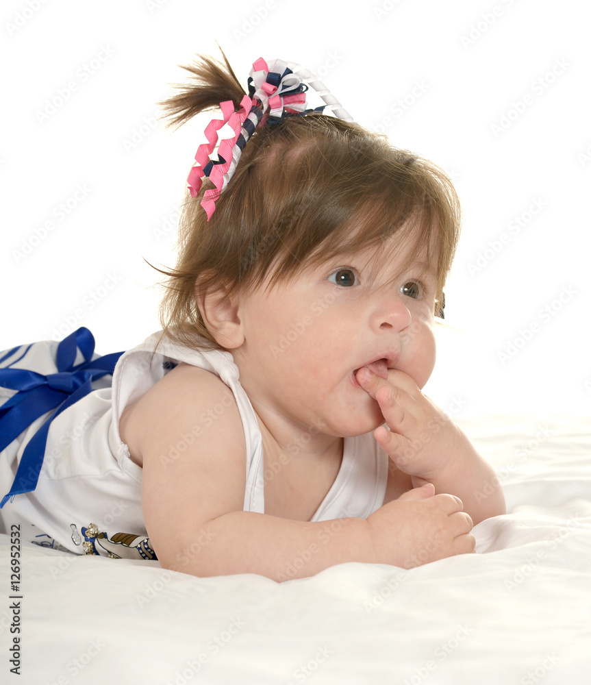 Baby girl lying on blanket