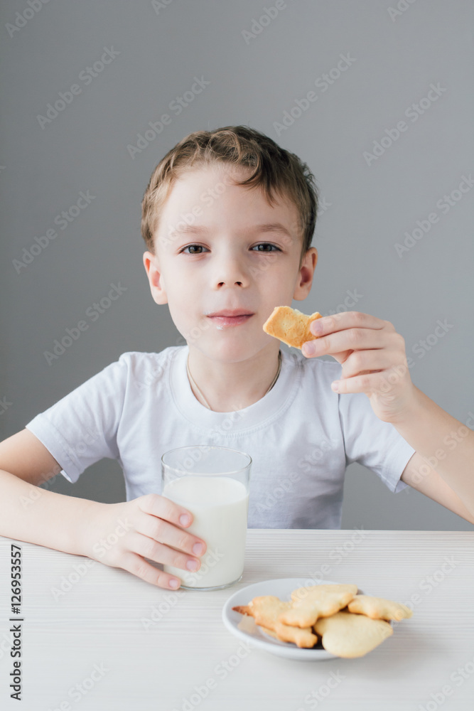 The child is happy to eat homemade biscuits with milk The child is happy to eat homemade biscuits with milk