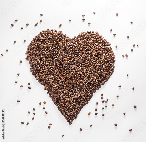 heart from coffee with scattered beans isolated on a white background