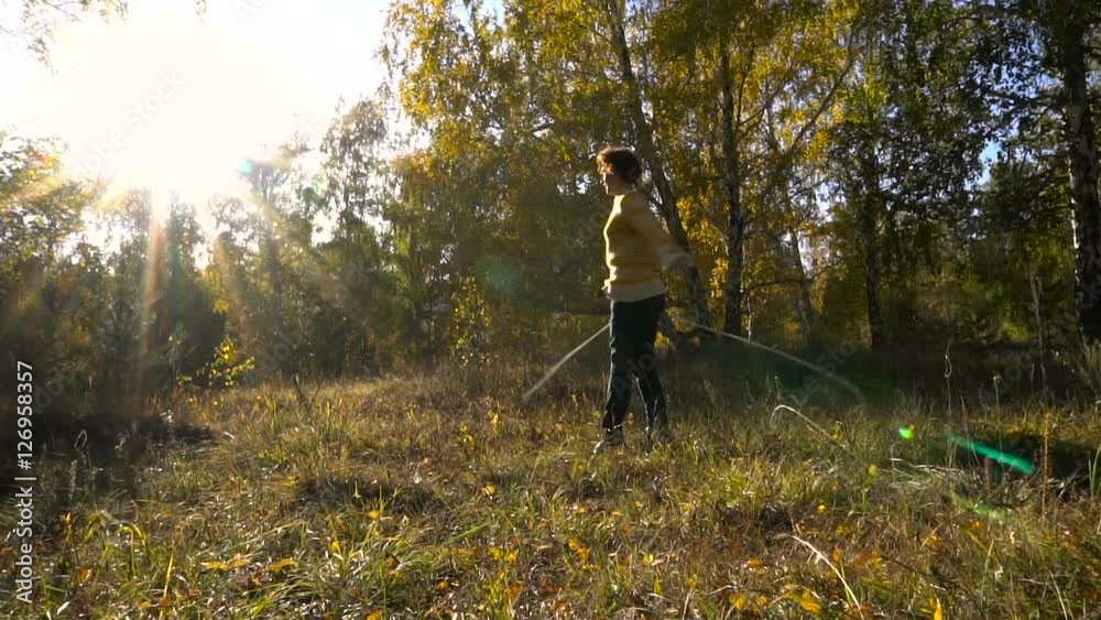 Slow Motion Acrobatics Young Girl Autumn Forest on Sunny Day. Slow Motion Acrobatics Young Girl Autumn Forest on Sunny Day.