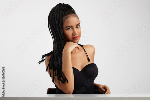 black woman in studio shoot about african braids