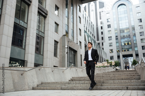 Businessman walking outdoors near business center © Drobot Dean