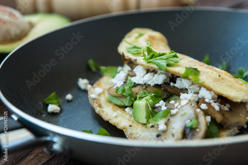 Crunchy mushroom, goat's cheese omelet with parsley and avocado