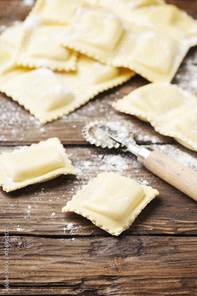 Uncooked ravioli on the wooden table