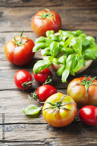 Green basil and red sweet tomato