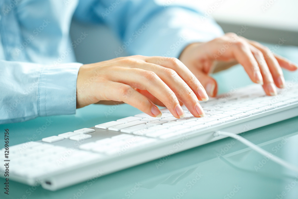 Woman office worker typing on the keyboard