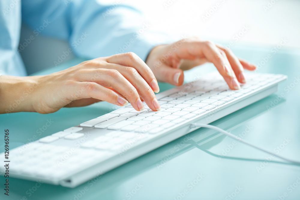 Woman office worker typing on the keyboard Woman office worker typing on the keyboard