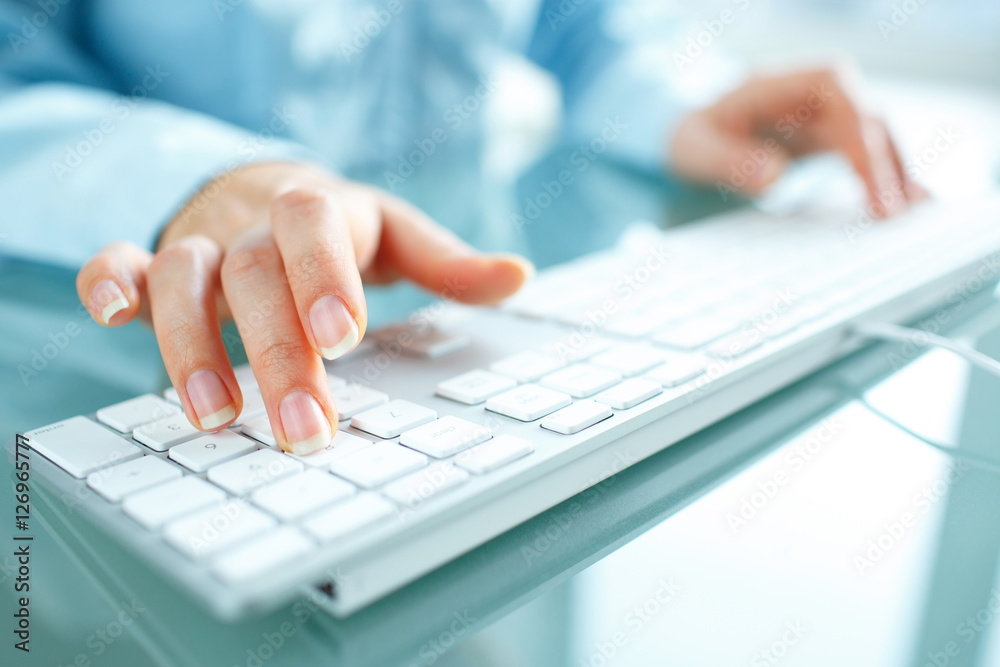 Woman office worker typing on the keyboard Woman office worker typing on the keyboard